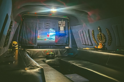 Interior of black hearse with colored lights